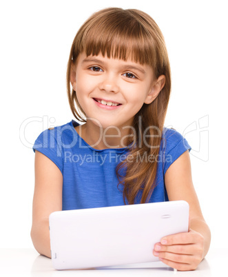 Young cheerful girl is using tablet