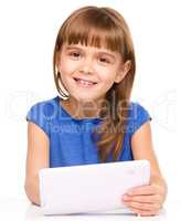 Young cheerful girl is using tablet