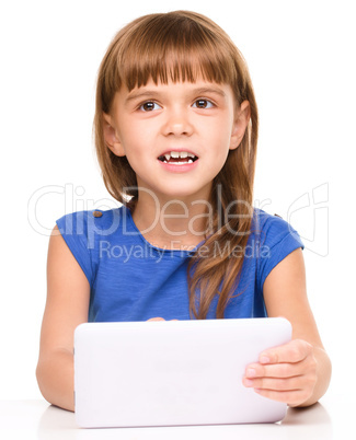 Young cheerful girl is using tablet