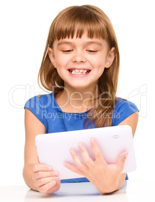 Young cheerful girl is using tablet