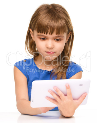 Young girl is using tablet while studying