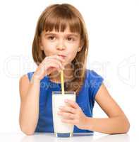 Cute little girl with a glass of milk