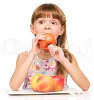 Little girl with red apples