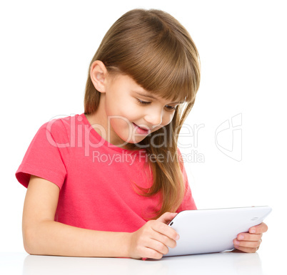 Young girl is using tablet while studying