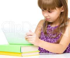 Young cheerful girl is using tablet