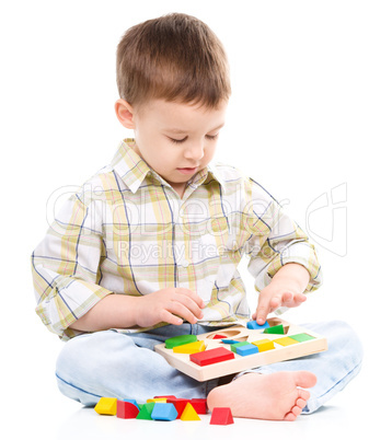 Little boy is playing with toys