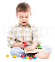 Little boy is playing with toys