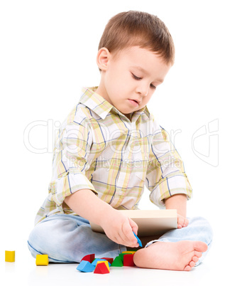 Little boy is playing with toys