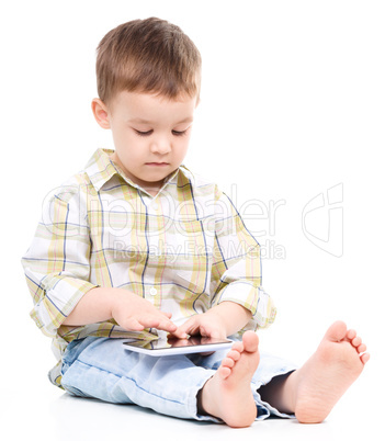 Young boy is using tablet