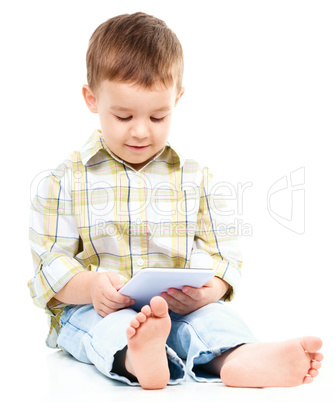 Young boy is using tablet