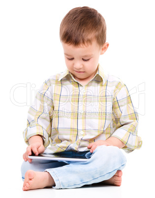 Young boy is using tablet