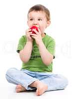 Portrait of a cute little boy with red apple