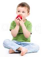 Portrait of a cute little boy with red apple