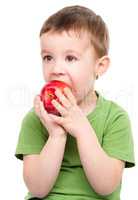Portrait of a cute little boy with red apple