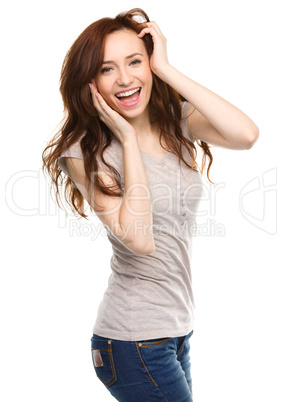 Woman is holding her face in astonishment