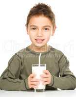 Cute boy with a glass of milk