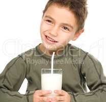 Cute boy with a glass of milk