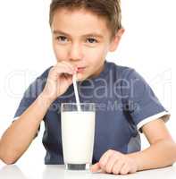 Cute boy with glass of milk