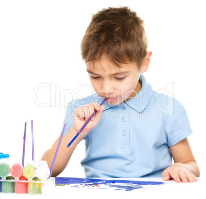 Boy is playing with paints