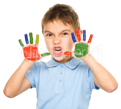 Portrait of a cute boy playing with paints