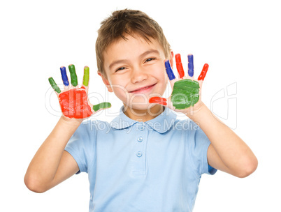 Portrait of a cute boy playing with paints