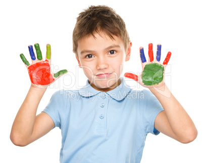 Portrait of a cute boy playing with paints