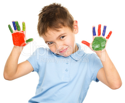 Portrait of a cute boy playing with paints