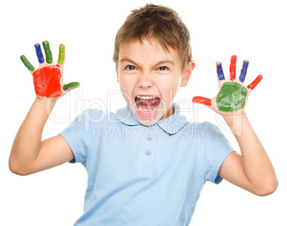 Portrait of a cute boy playing with paints