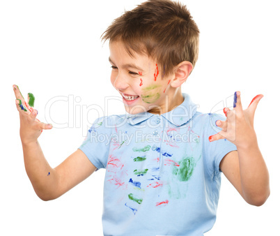 Portrait of a cute boy playing with paints