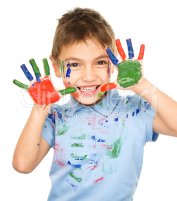 Portrait of a cute boy playing with paints