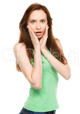 Woman is holding her face in astonishment