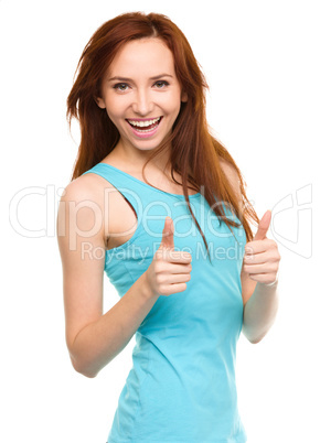 Woman is showing thumb up gesture