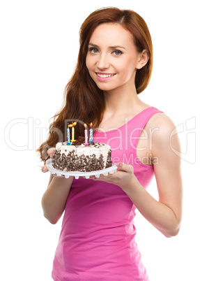 Young woman with anniversary cake