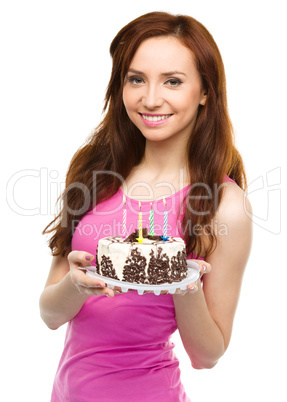 Young woman with anniversary cake