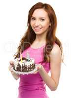 Young woman with anniversary cake