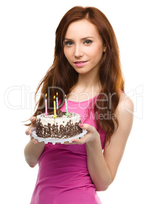 Young woman with anniversary cake