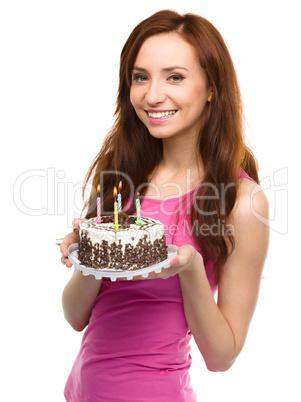 Young woman with anniversary cake