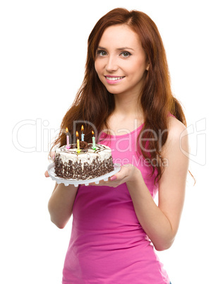 Young woman with anniversary cake