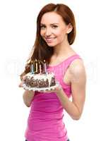 Young woman with anniversary cake