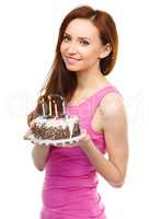 Young woman with anniversary cake