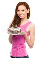 Young woman with anniversary cake