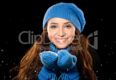 Young happy woman under snowfall