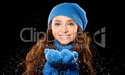 Young happy woman under snowfall