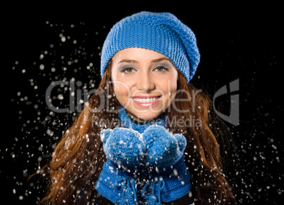 Young happy woman under snowfall