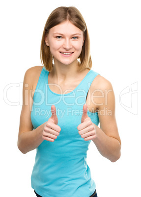 Woman is showing thumb up gesture