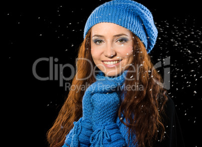 Young happy woman under snowfall