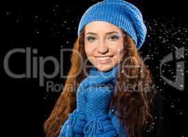 Young happy woman under snowfall