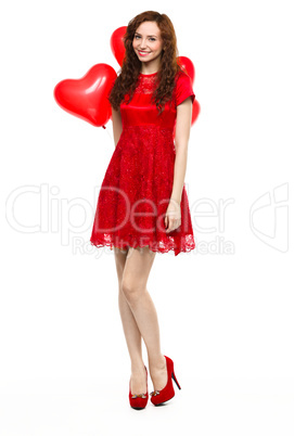 Young woman holding heart-shaped balloons