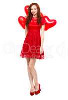 Young woman holding heart-shaped balloons