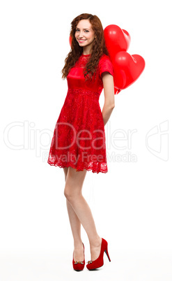 Young woman holding heart-shaped balloons